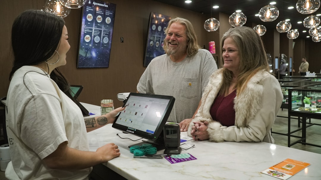 Happy cannabis consumers having a great conversation with employees in a dispensary.